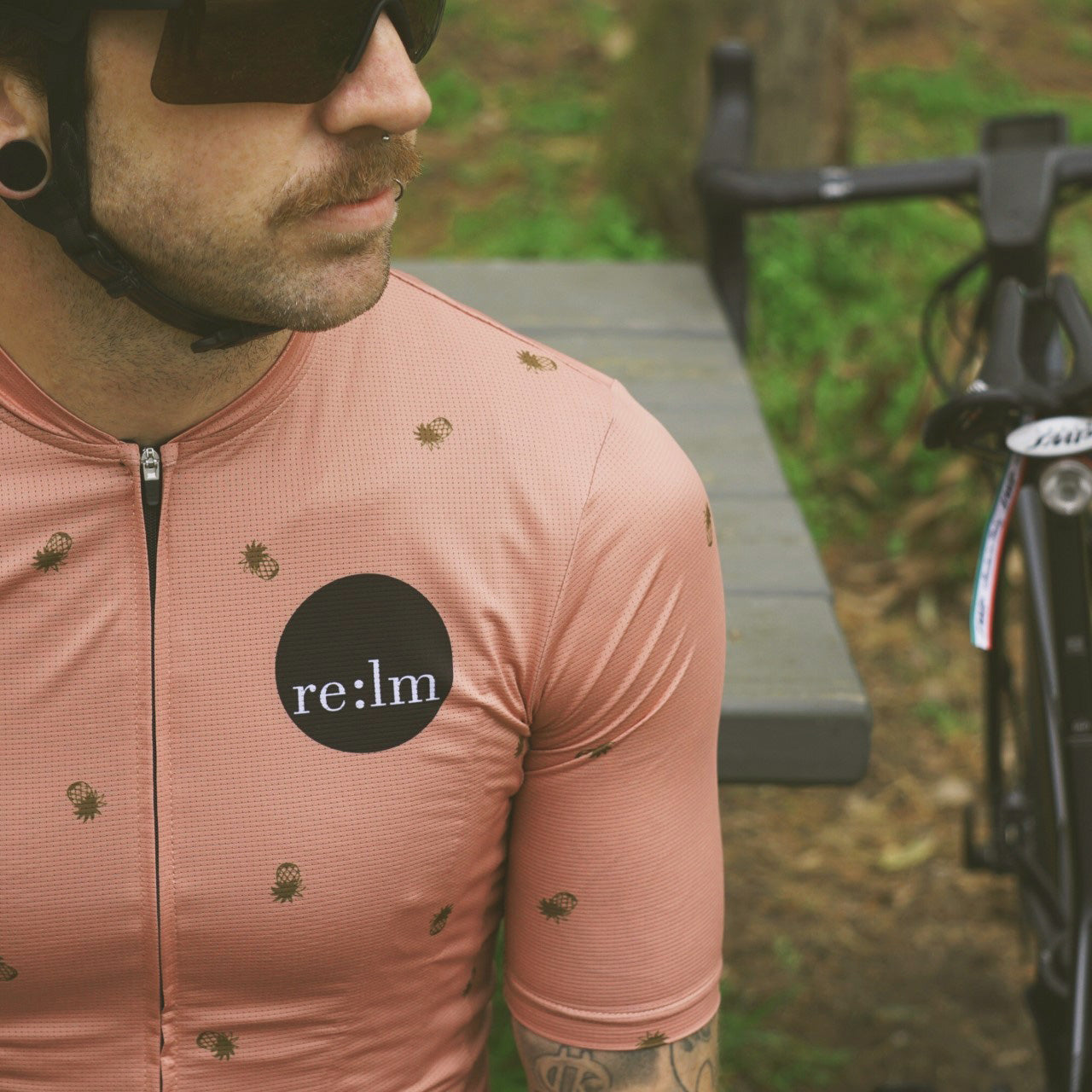 Man wearing Relm Cycling jersey in pines