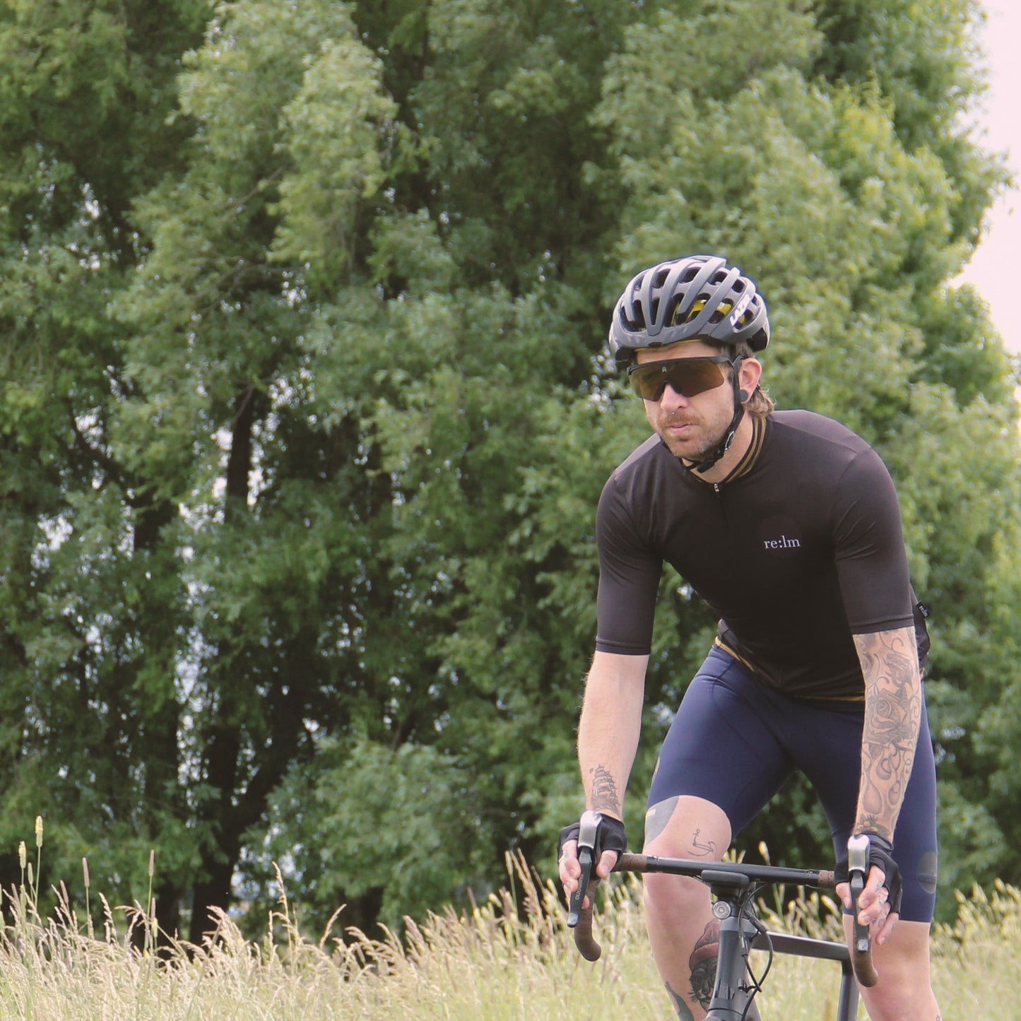 Man wearing Relm Cycling jersey in varsity