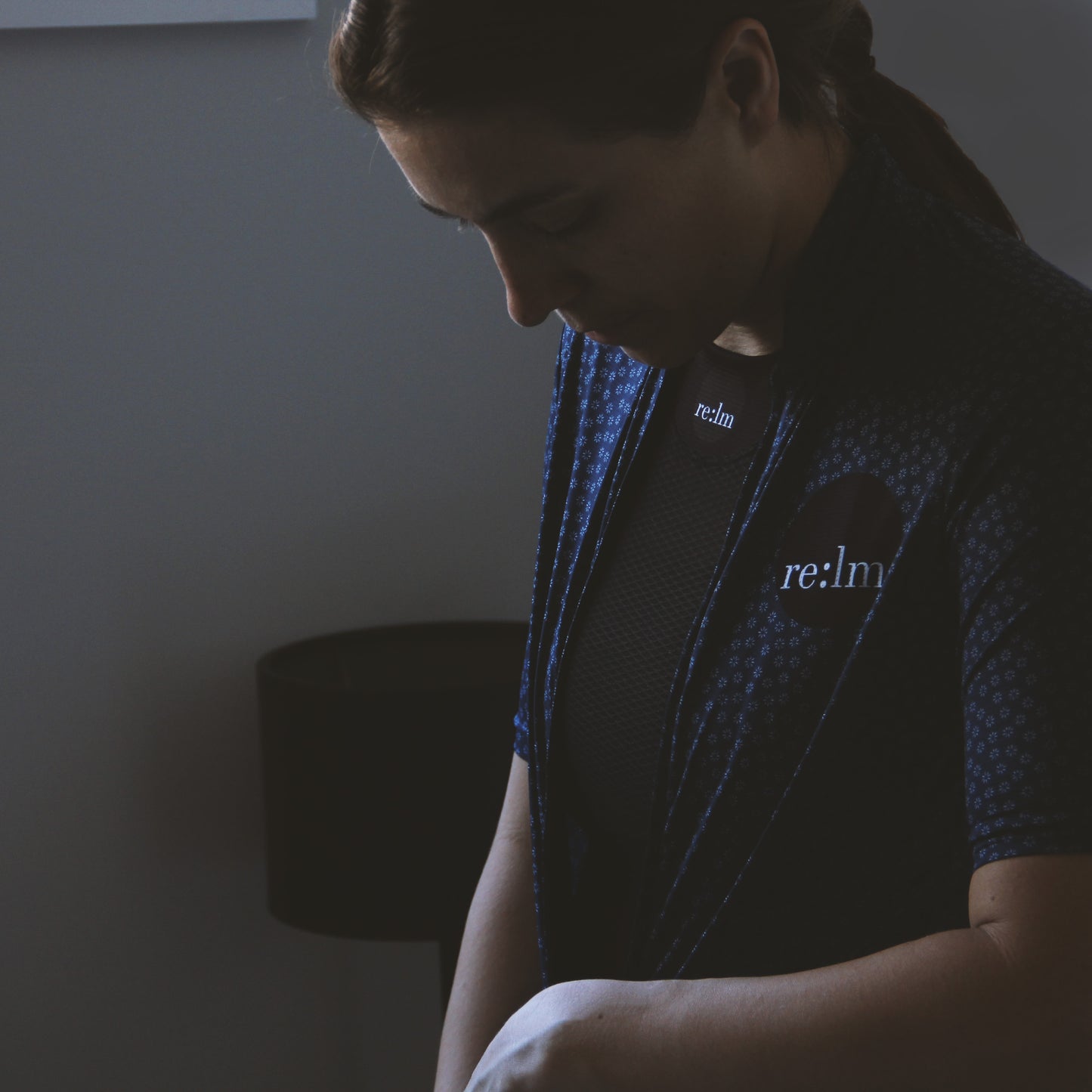 Women wearing Relm Cycling black sleeveless base layer zipping up bloom cycling jersey