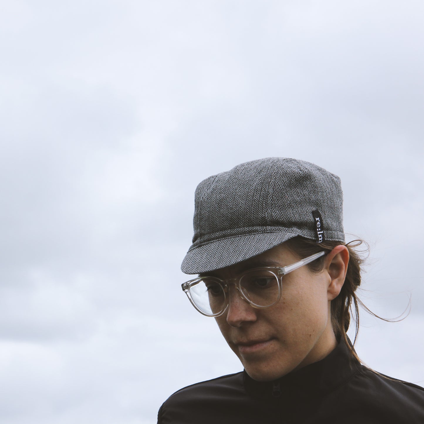 Woman wearing tweed look cycling cap in grey