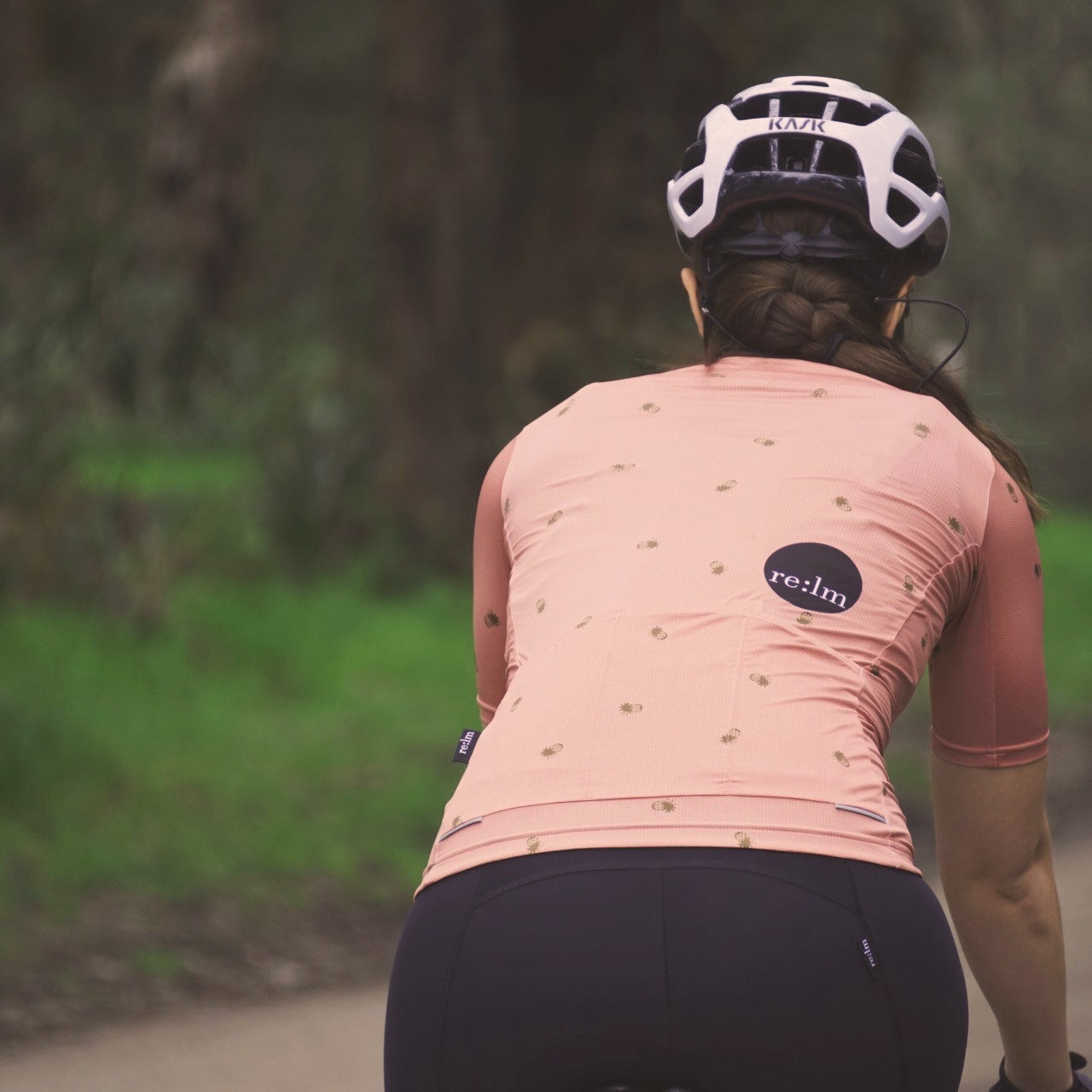 Woman wearing Evolve Relm Cycling jersey in pines